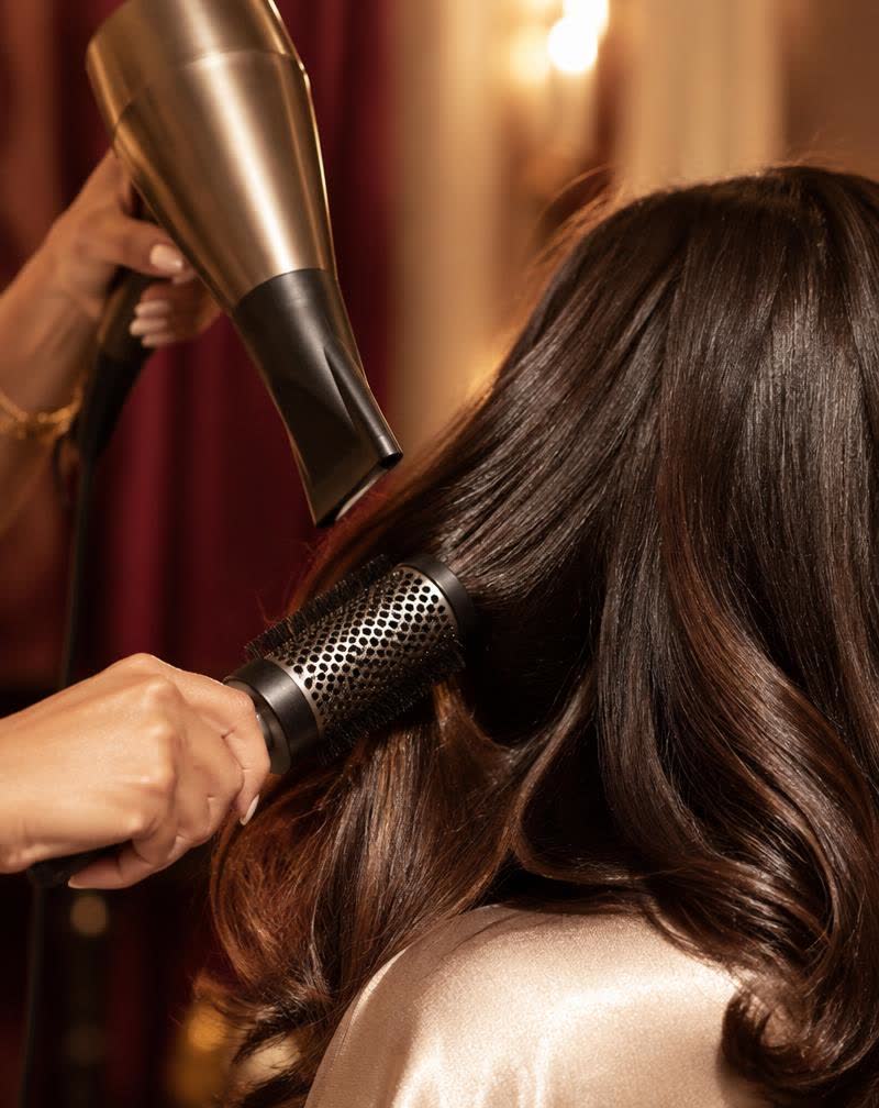 Stylist finishing a glossy blow-dry